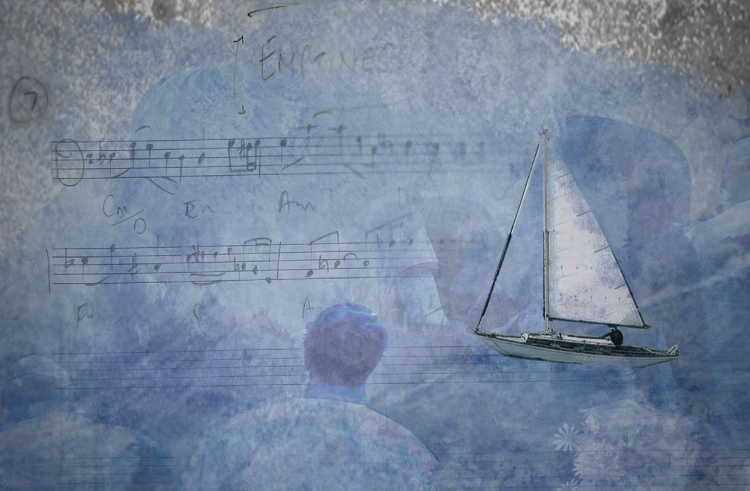 A man watching a small sailing boat