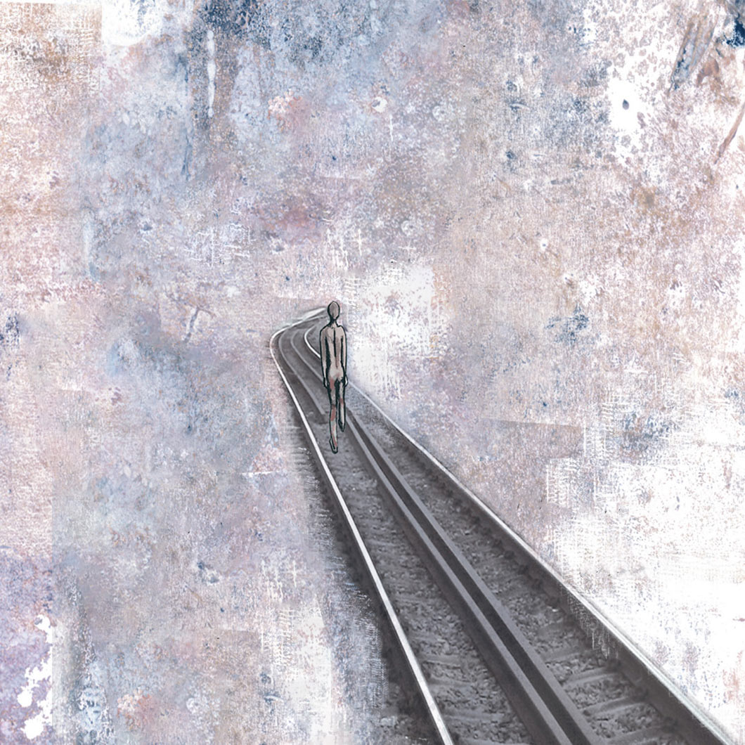 A man walking away down a railway track